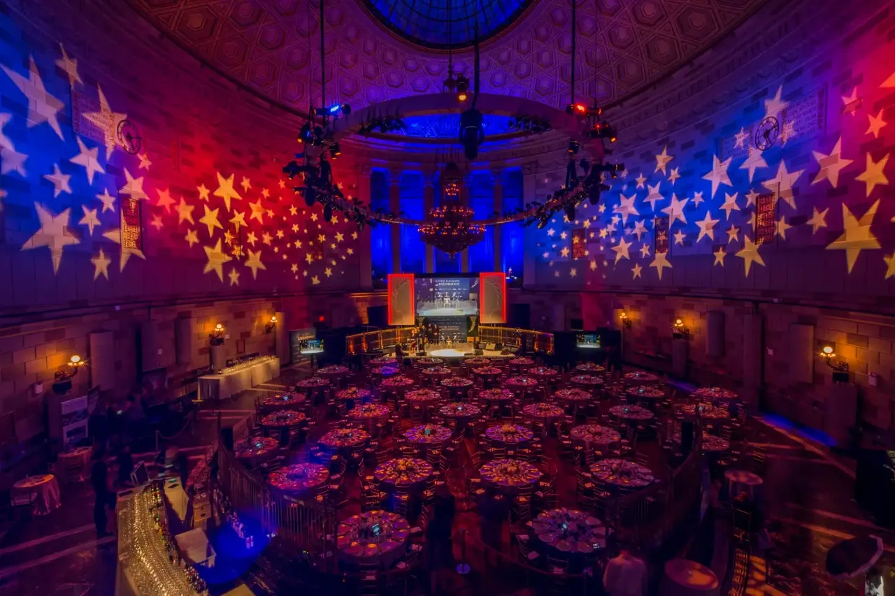 Milestone celebration with cinematic lighting in Gotham Hall's ballroom